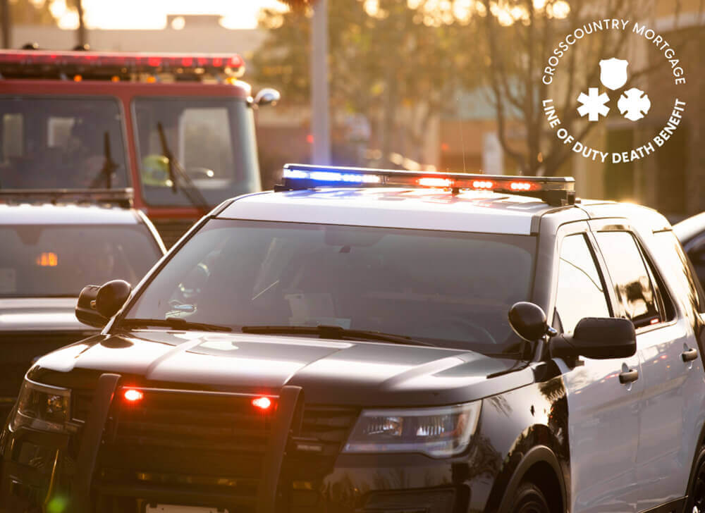 Emergency vehicles at scene, including two police cars and an ambulance