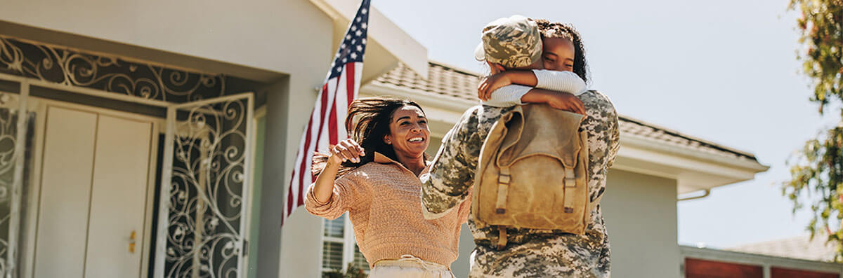 veteran-welcome-home-va-mortgage-loan A veteran’s family welcoming him to their new home purchased with a VA mortgage loan.