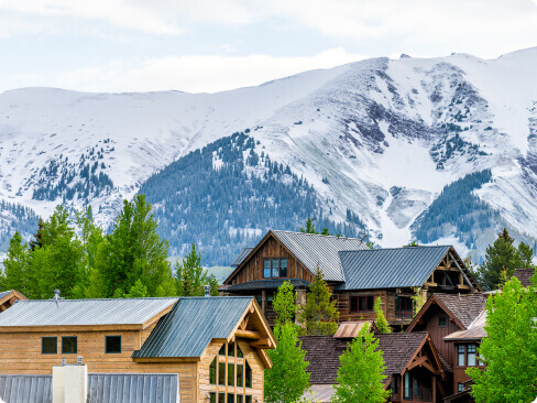 View of a mountain with cabins below.