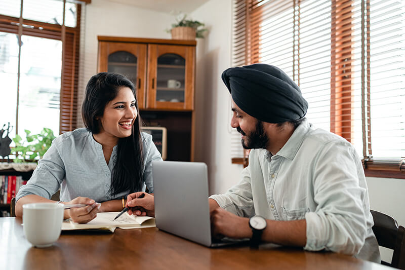 Couple checking if they meeting credit scores for first time homebuyer requirements