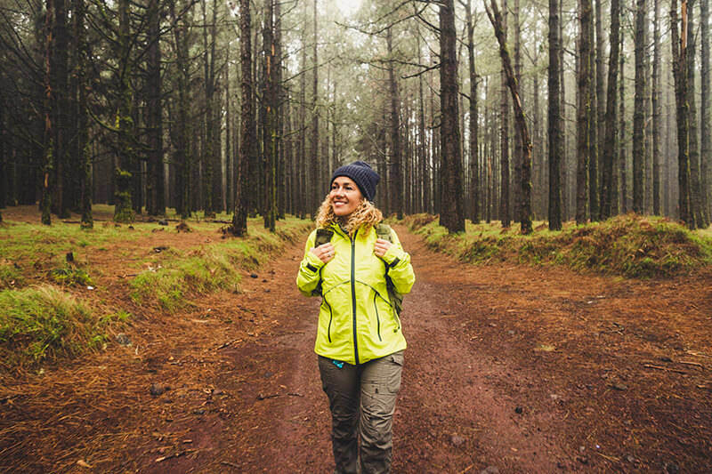 A woman walking through the woods