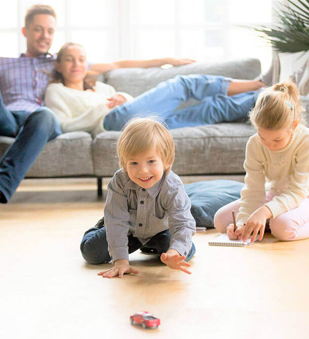 A little boy crawling towards his toy truck