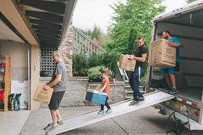 Family moving their boxes into their dream home