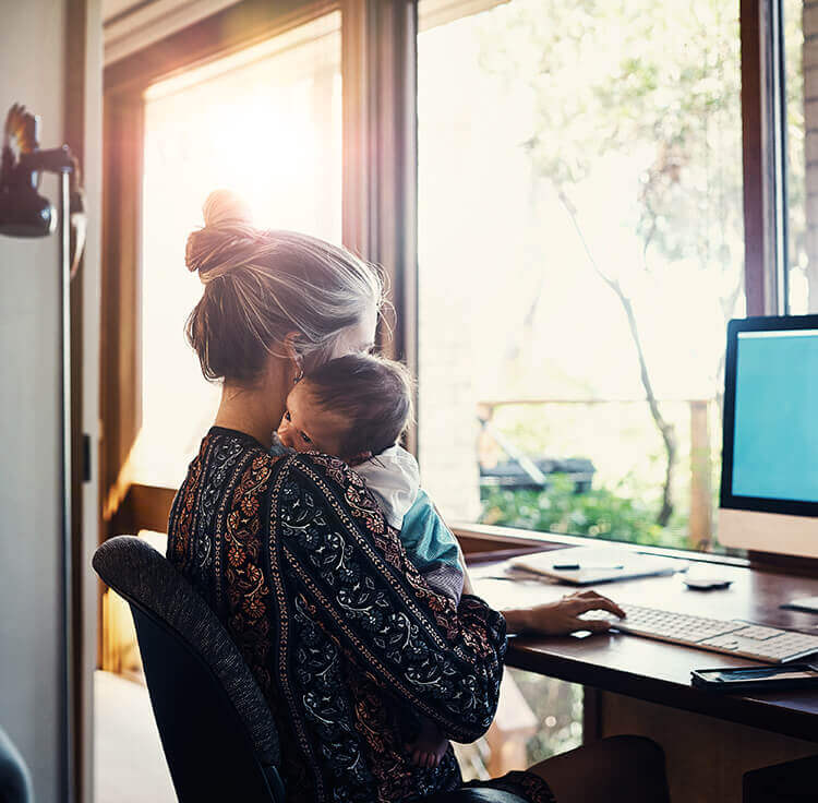 A borrower holding her baby and learning more about buying a home