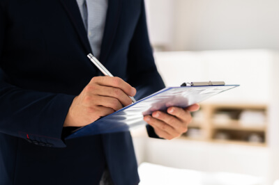 A home appraiser holding a clipboard