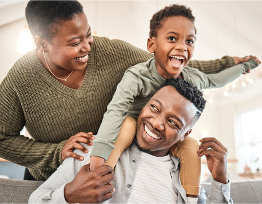 First-time homebuyers and their child playing in their new home