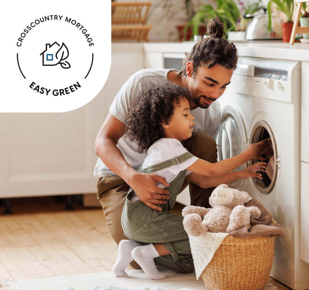 A father and daughter unload the dryer together in their energy-efficient home