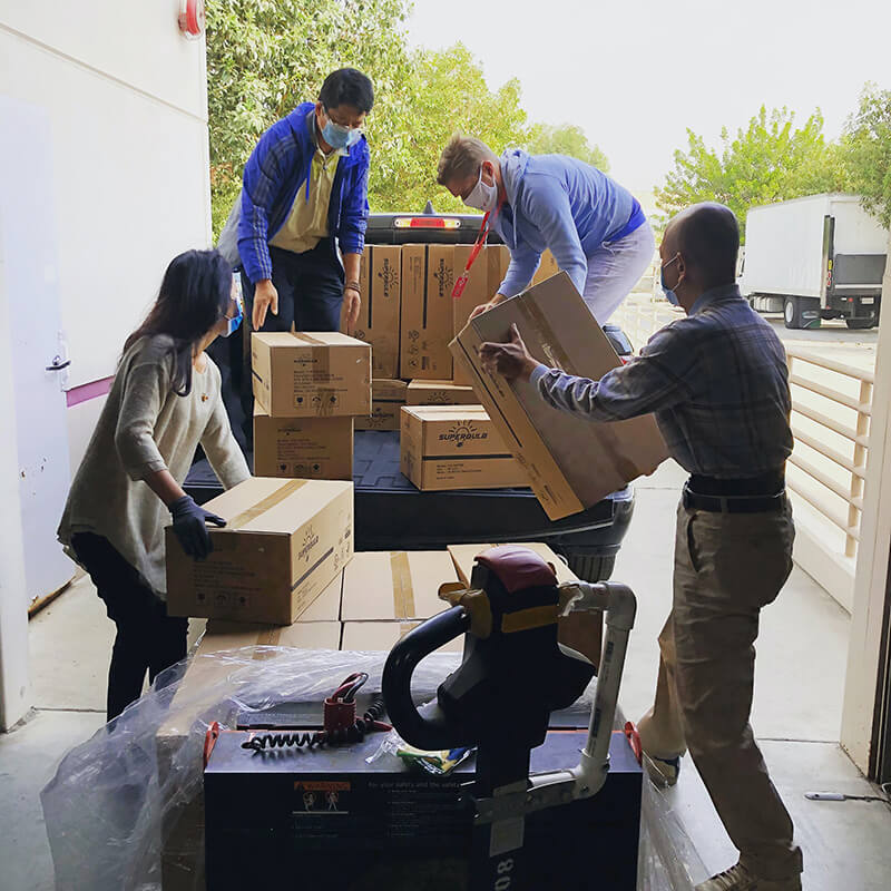 Team of people loading boxes into a truck