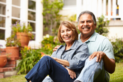 Couple sits at dining room table to discuss what a reverse mortgage is. 