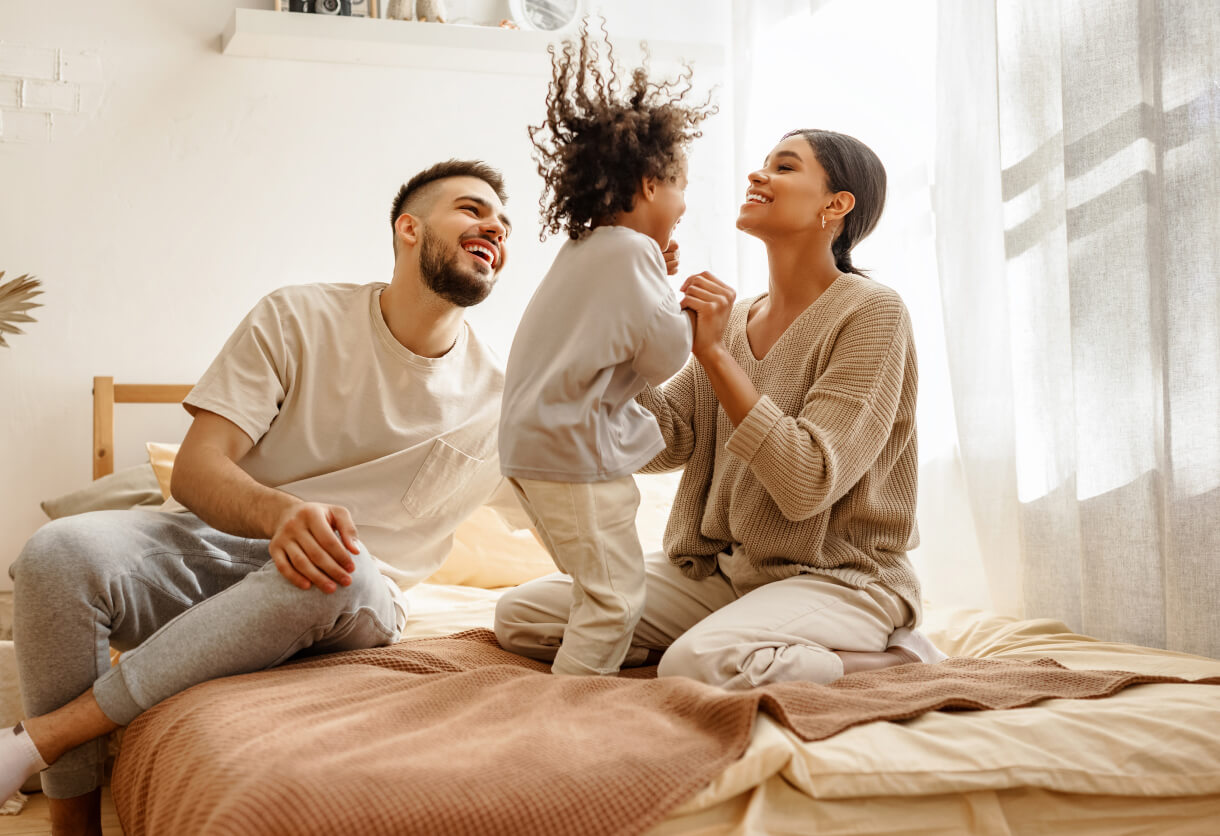 First-time homebuyers and their family celebrating in their new home