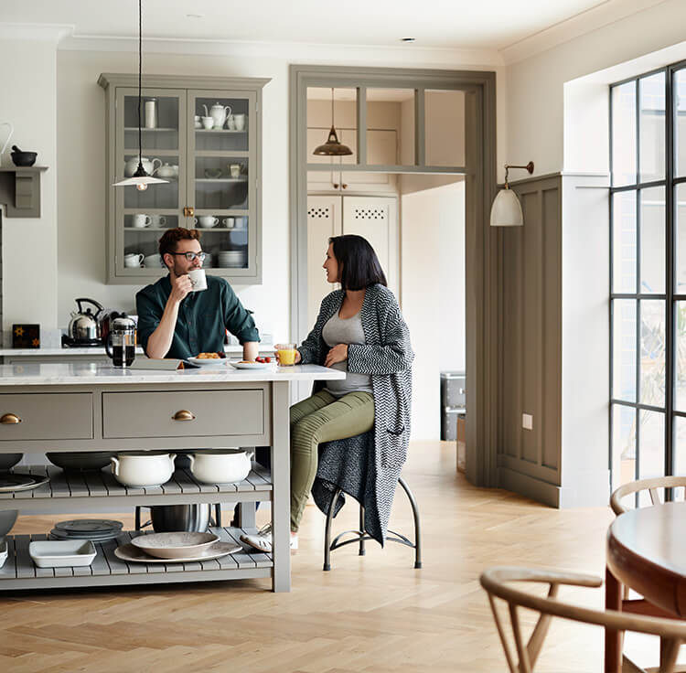 Homeowners eating breakfast and discussing what a jumbo loan is and the requirements